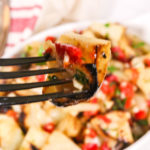 A scoop in the warm bowl of potato salad.