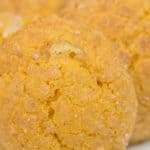 Close-up of a round, golden-brown Pumpkin Snickerdoodle Cookie with a slightly cracked surface and visible sugar crystals.